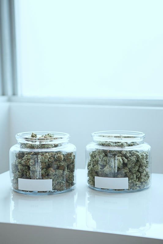 full of kush in clear glass jars on table
