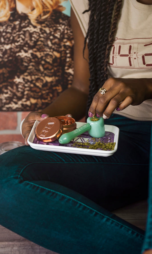 person preparing spoon pipe while sitting