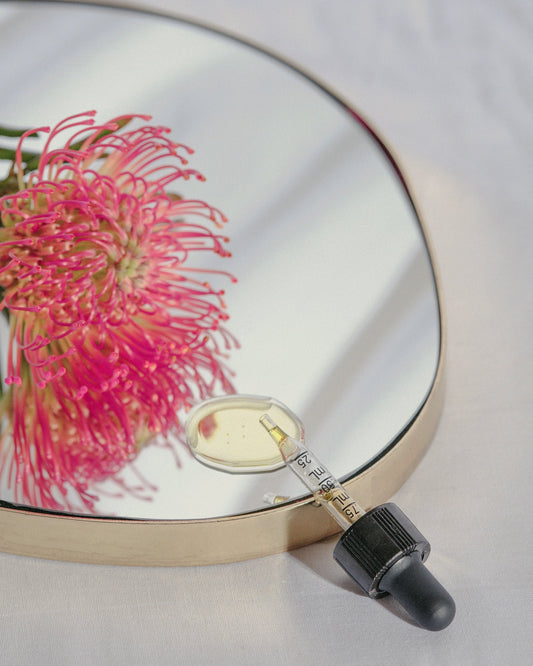 a mirror with a pink flower on it