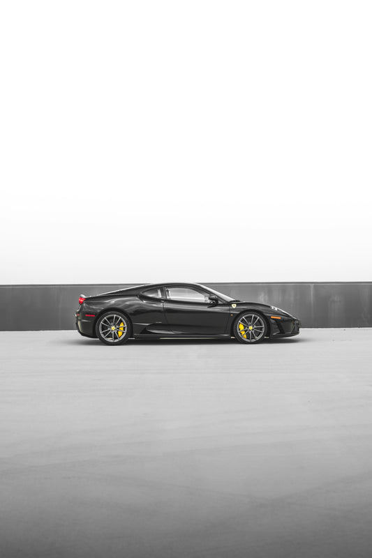 a black sports car parked in a parking lot