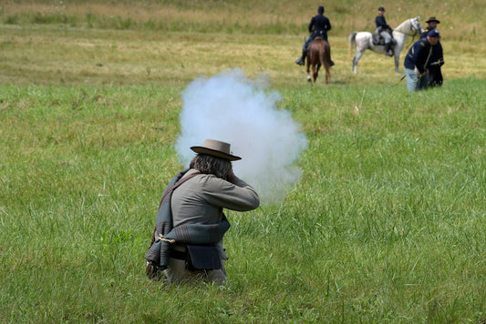 A group of men on horses in a field