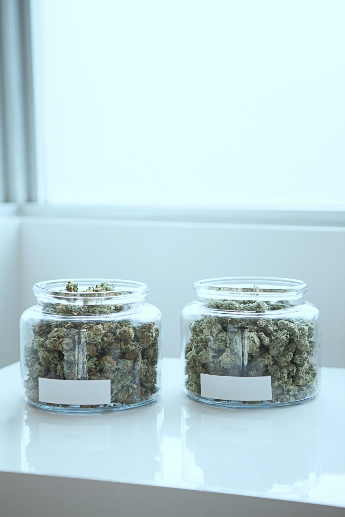 full of kush in clear glass jars on table