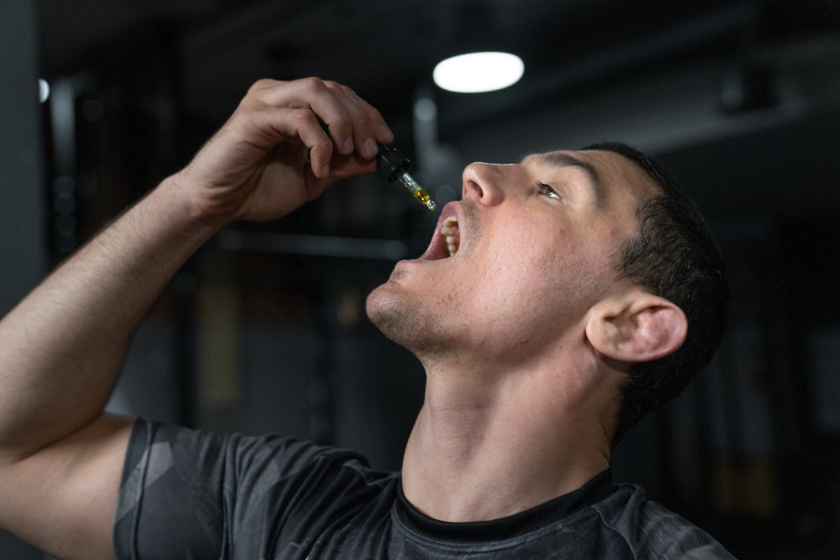 Man taking liquid from dropper into mouth