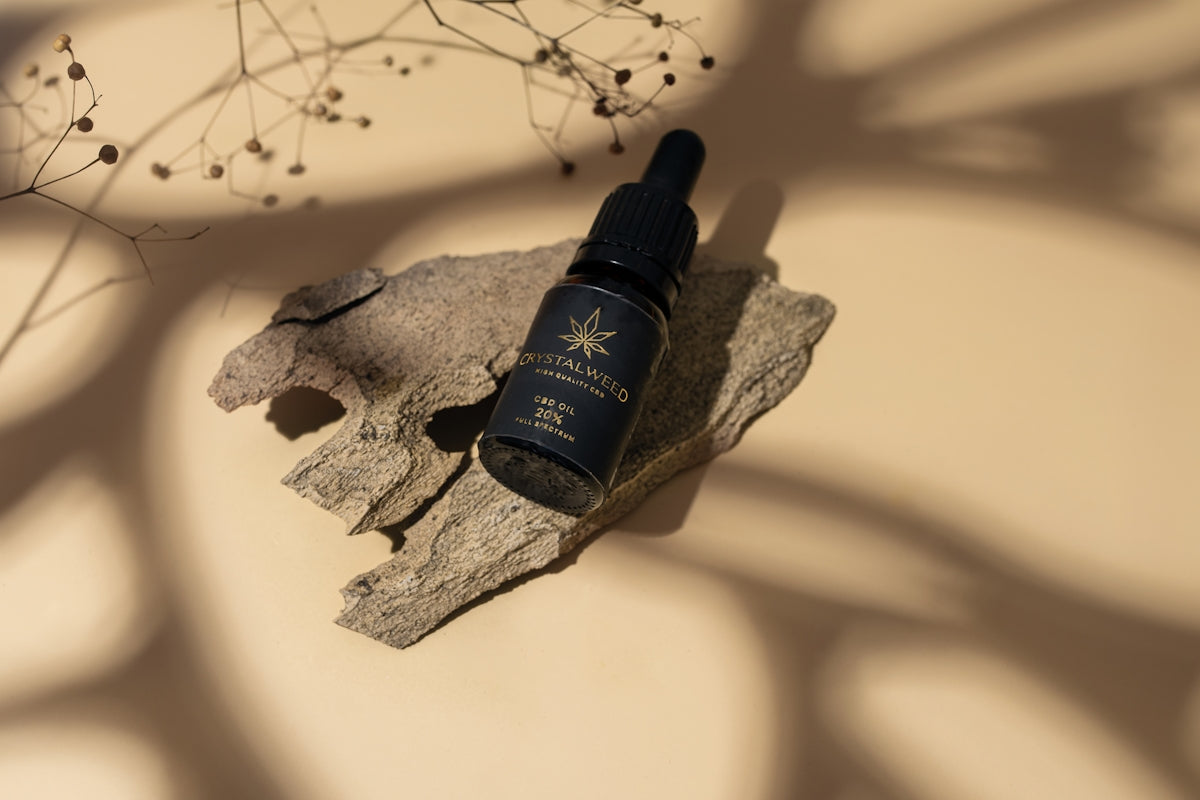 a bottle of perfume sitting on top of a rock