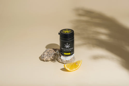a bottle of cb sitting on top of a rock next to a lemon