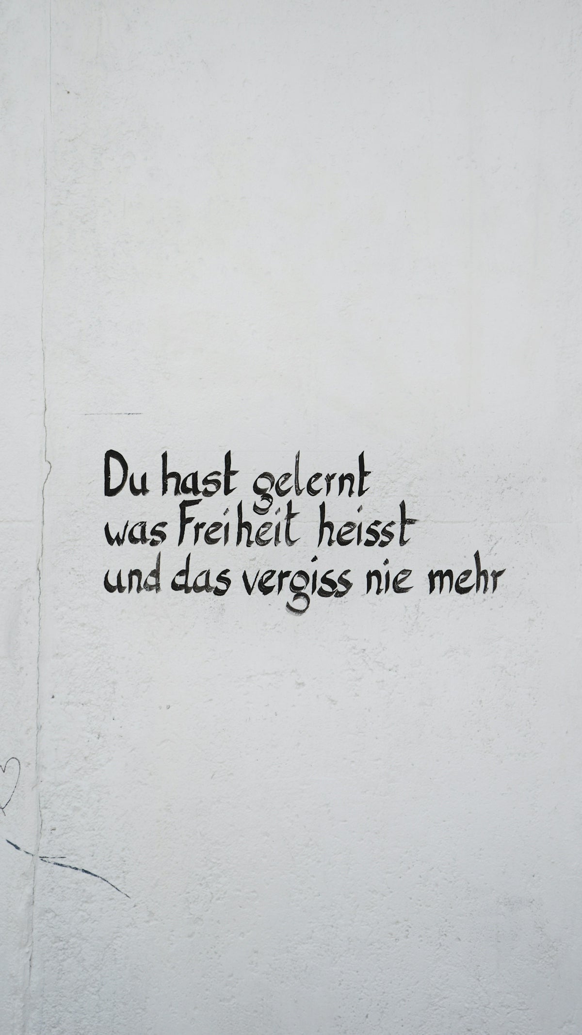 a white wall with black writing on it