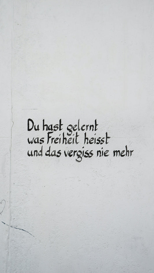 a white wall with black writing on it