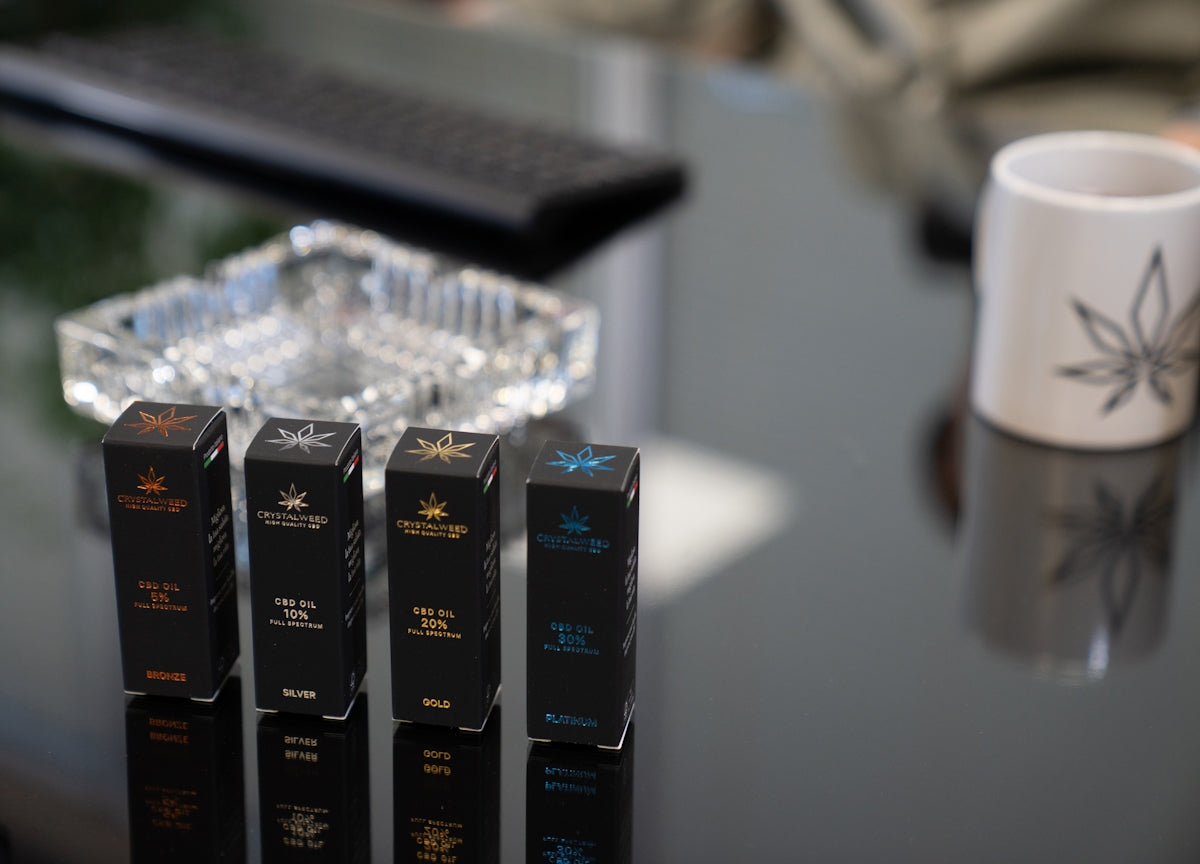a table with three boxes and a cup on it