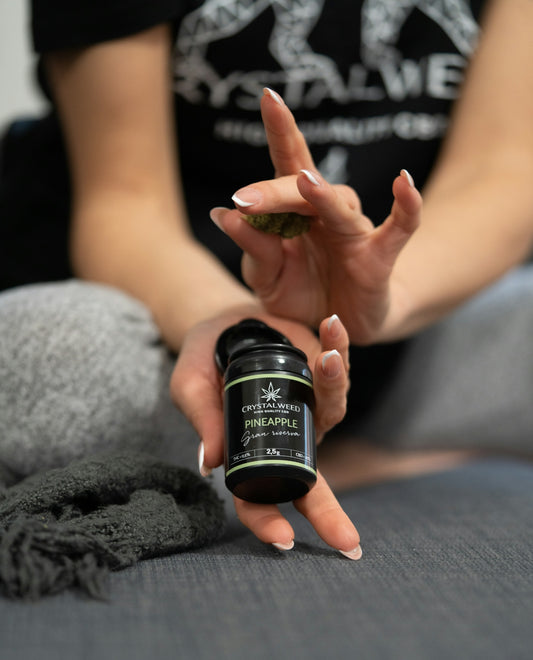 a woman holding a bottle of cannabis oil