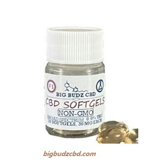 a bottle of cbd softgels next to some gold coins