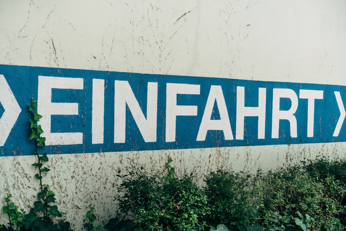 a blue street sign sitting on the side of a building
