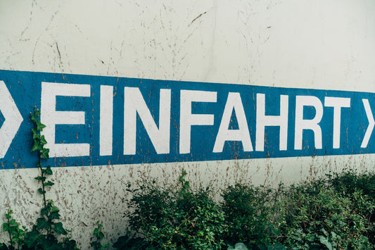 a blue street sign sitting on the side of a building