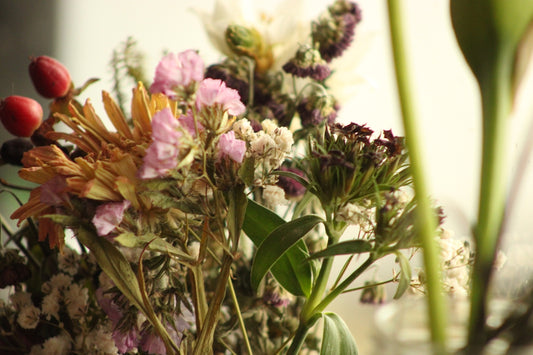 a vase filled with lots of different types of flowers
