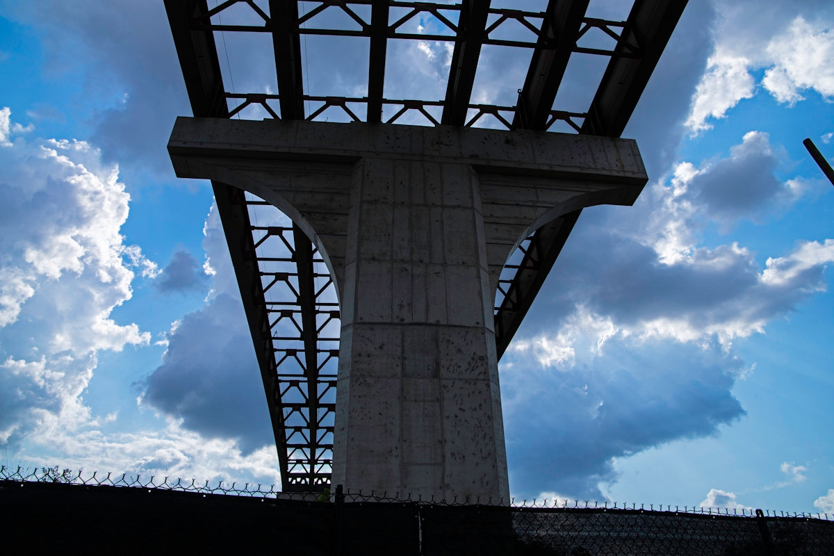A tall clock tower sitting under a cloudy blue sky