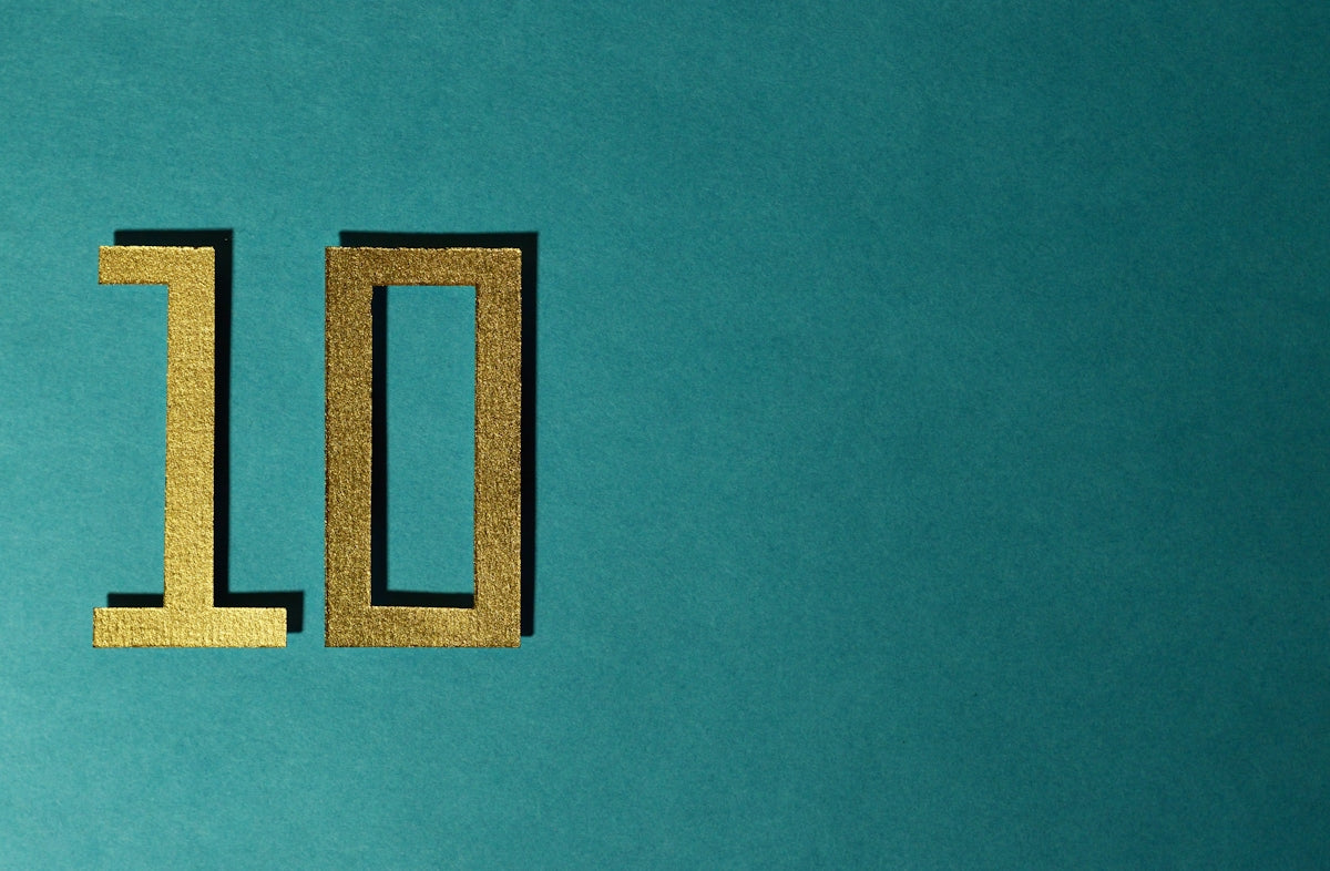 The number 10 is gold on a teal background.